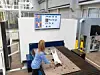 Frau mit Sorting Guide von Trumpf in Industriehalle